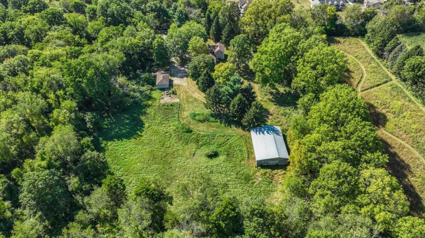 country home with acreage and outbuildings